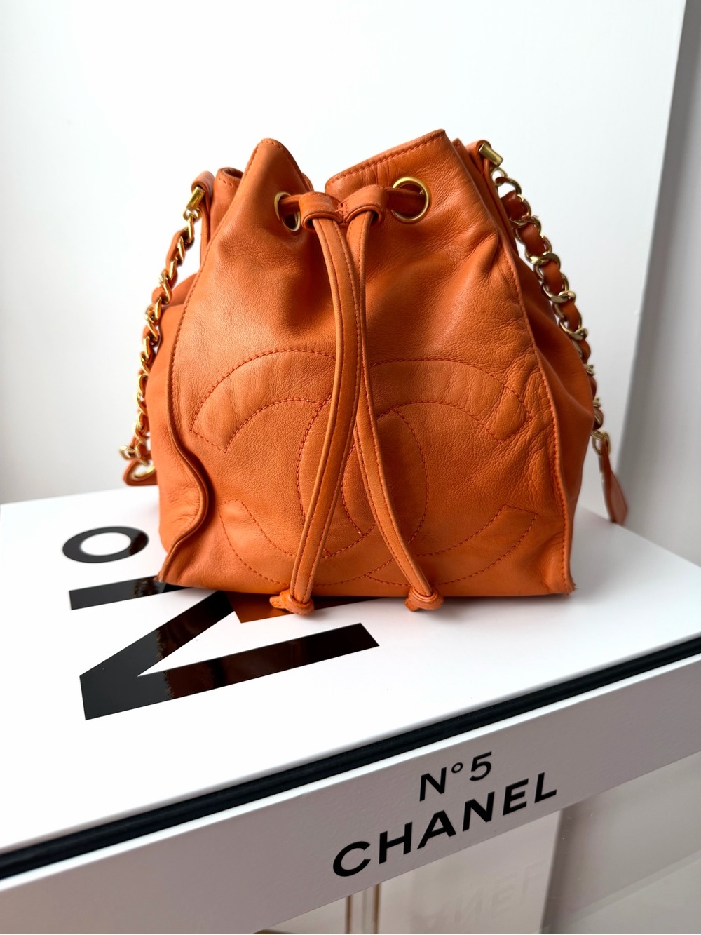 Vintage CHANEL Orange Leather Drawstring Bucket Shoulder Bag with Gold Chain